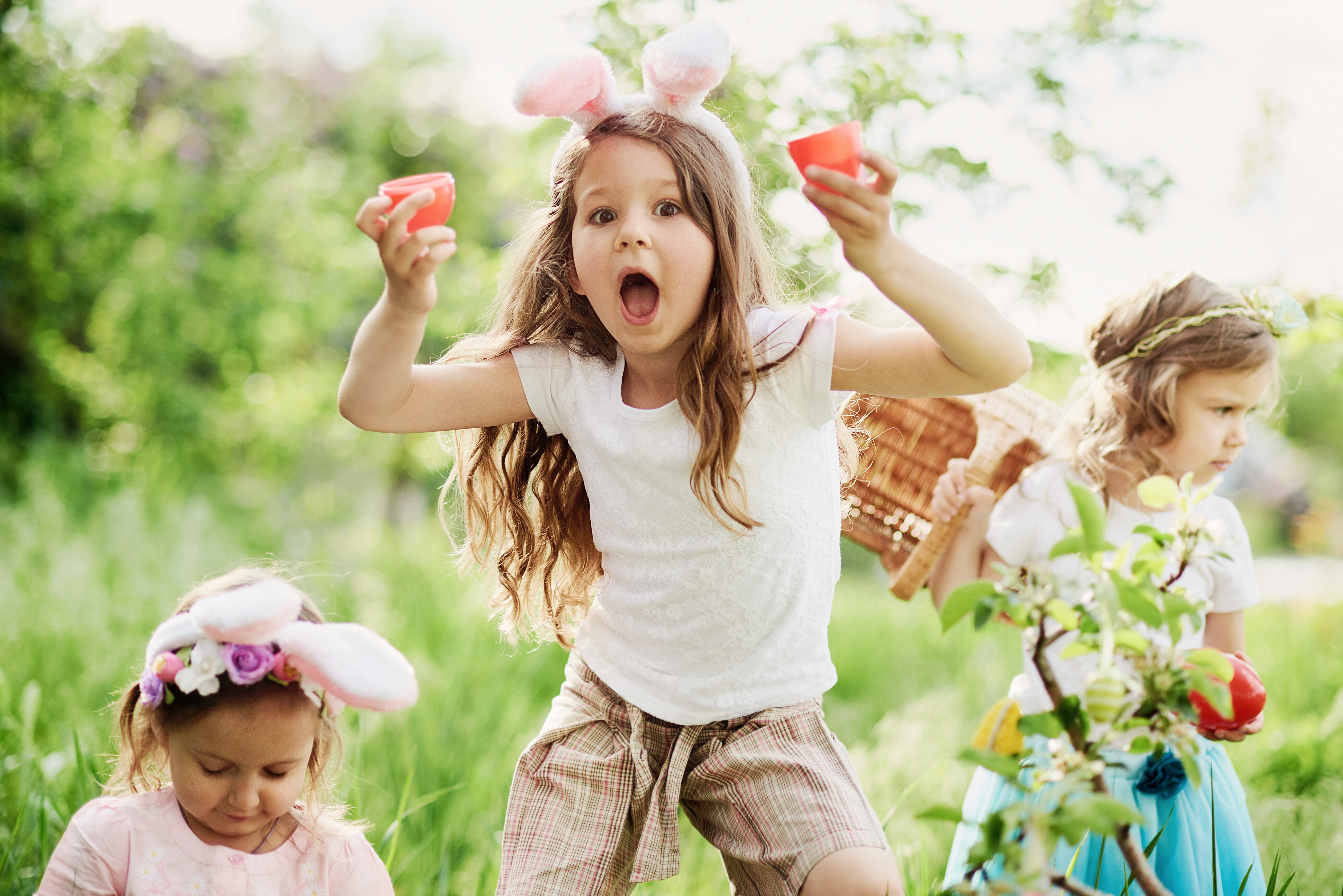 Easter Egg Hunt. Group Of Children Wearing Bunny Ears Running To